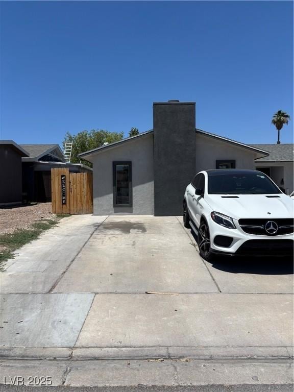 4732 El Tesoro Ave, Las Vegas, NV 89121 - view of front of property with stucco siding and a chimney