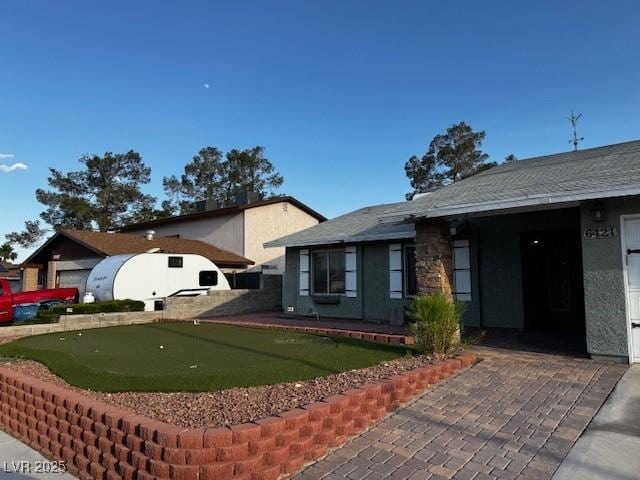 6421 Doby Peak Dr, Las Vegas, NV 89108 - view of front of house with an area to practice putting