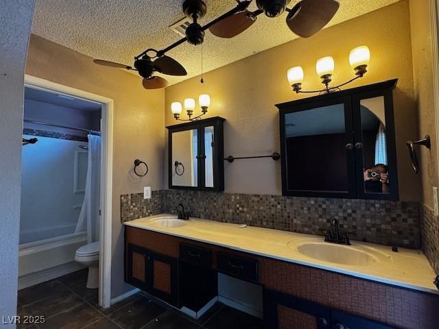 6421 Doby Peak Dr, Las Vegas, NV 89108 - bathroom featuring tile patterned floors, double vanity, toilet, a textured ceiling, and ceiling fan