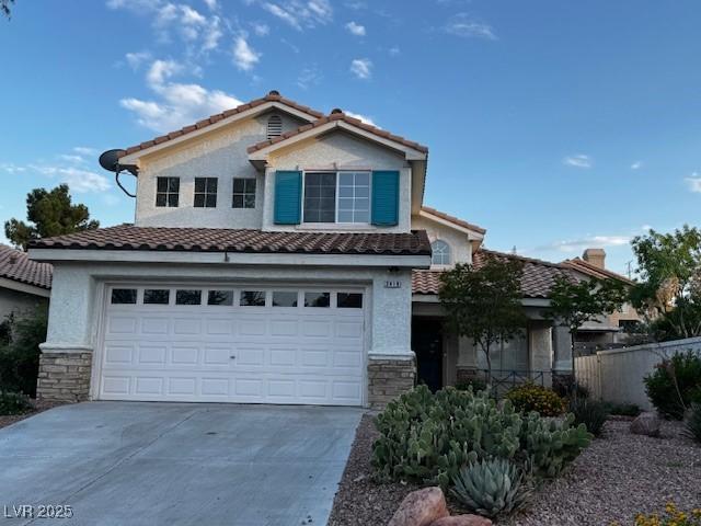 2419 Pebble Springs Ct, Henderson, NV 89074 - view of front facade with concrete driveway, an attached garage, a tiled roof, and stone siding