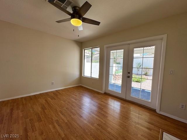 2419 Pebble Springs Ct, Henderson, NV 89074 - empty room featuring french doors, wood finished floors, and a ceiling fan