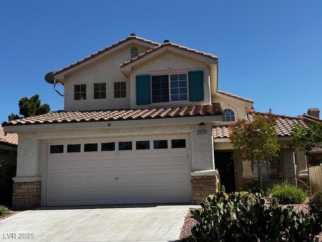 2419 Pebble Springs Ct, Henderson, NV 89074 - mediterranean / spanish home featuring a tile roof, driveway, stucco siding, and a garage