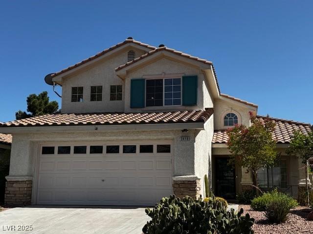 2419 Pebble Springs Ct, Henderson, NV 89074 - mediterranean / spanish home featuring a tile roof, a garage, concrete driveway, stone siding, and stucco siding