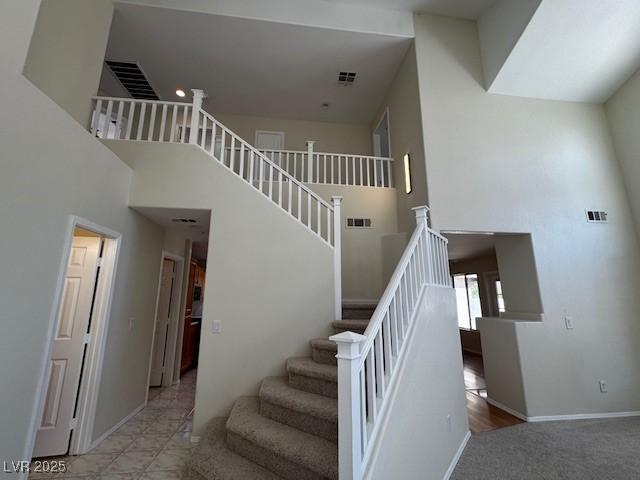 2419 Pebble Springs Ct, Henderson, NV 89074 - staircase with a towering ceiling and baseboards