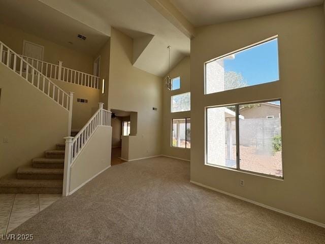 2419 Pebble Springs Ct, Henderson, NV 89074 - unfurnished living room featuring stairs, high vaulted ceiling, carpet floors, and beam ceiling