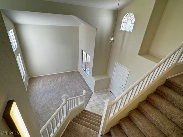 2419 Pebble Springs Ct, Henderson, NV 89074 - stairway featuring carpet floors and a towering ceiling