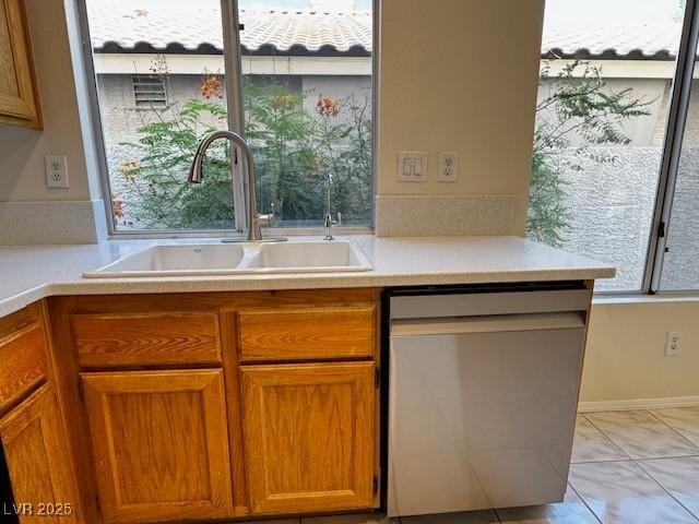 2419 Pebble Springs Ct, Henderson, NV 89074 - kitchen featuring stainless steel dishwasher, brown cabinets, and light countertops