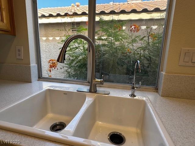 2419 Pebble Springs Ct, Henderson, NV 89074 - kitchen view of light countertops and brown cabinetry