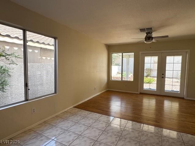 2419 Pebble Springs Ct, Henderson, NV 89074 - empty room featuring a ceiling fan, french doors, and light wood-style flooring
