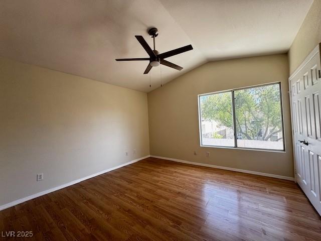 2419 Pebble Springs Ct, Henderson, NV 89074 - unfurnished bedroom with lofted ceiling, wood finished floors, and a ceiling fan