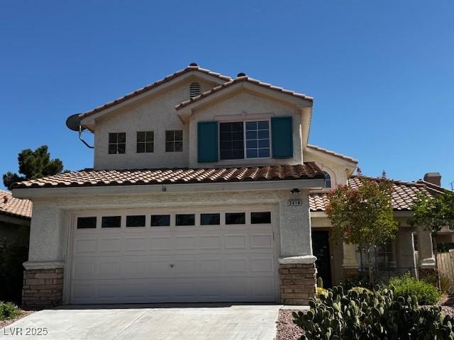 2419 Pebble Springs Ct, Henderson, NV 89074 - mediterranean / spanish house with a tile roof, driveway, stucco siding, and a garage
