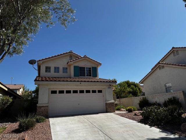 2419 Pebble Springs Ct, Henderson, NV 89074 - mediterranean / spanish-style house featuring a tile roof, stucco siding, and driveway
