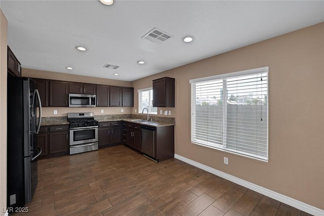 5816 Glory Canyon Way, Las Vegas, NV 89142 - kitchen featuring appliances with stainless steel finishes, a sink, baseboards, dark wood-style floors, and recessed lighting