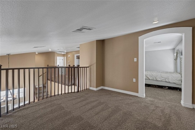 5816 Glory Canyon Way, Las Vegas, NV 89142 - carpeted spare room with a textured ceiling, arched walkways, and baseboards