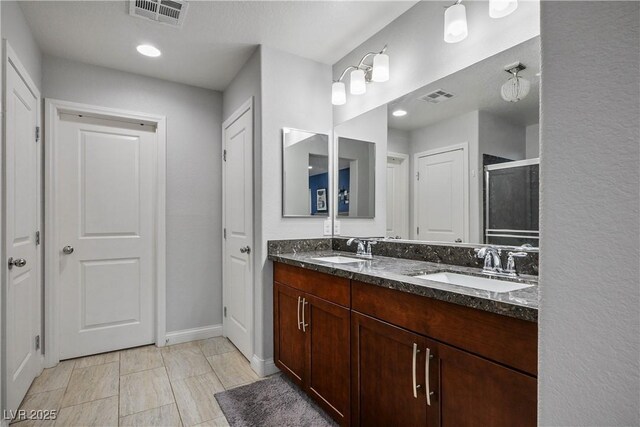 51 Morning Mimosa Ct, Henderson, NV 89012 - bathroom with double vanity, baseboards, a shower stall, and recessed lighting