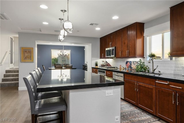 51 Morning Mimosa Ct, Henderson, NV 89012 - kitchen with a sink, appliances with stainless steel finishes, healthy amount of natural light, dark countertops, and recessed lighting