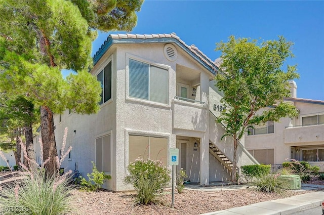 5196 Mandalay Springs Dr Unit 101, Las Vegas, NV 89120 - view of property featuring stairs and stucco siding