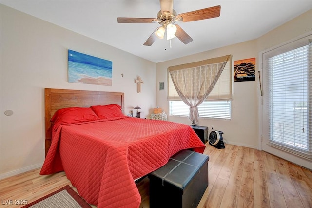 5196 Mandalay Springs Dr Unit 101, Las Vegas, NV 89120 - bedroom featuring light wood-style flooring, a ceiling fan, and access to exterior