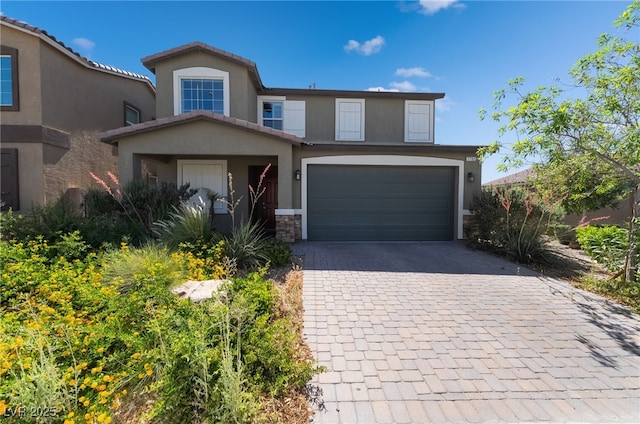 7732 Bandon Cliffs St, North Las Vegas, NV 89084 - view of front of house featuring decorative driveway, stone siding, a garage, and stucco siding