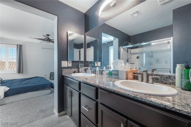 7732 Bandon Cliffs St, North Las Vegas, NV 89084 - full bathroom with tile patterned flooring, double vanity, a stall shower, ceiling fan, and a textured wall
