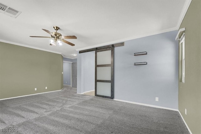 1306 Big Tree Ave, North Las Vegas, NV 89031 - spare room featuring crown molding, ceiling fan, carpet floors, baseboards, and a barn door