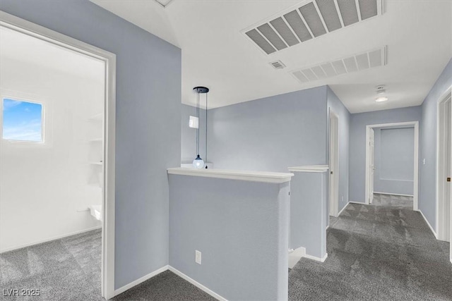 1306 Big Tree Ave, North Las Vegas, NV 89031 - corridor with dark carpet, an upstairs landing, and baseboards