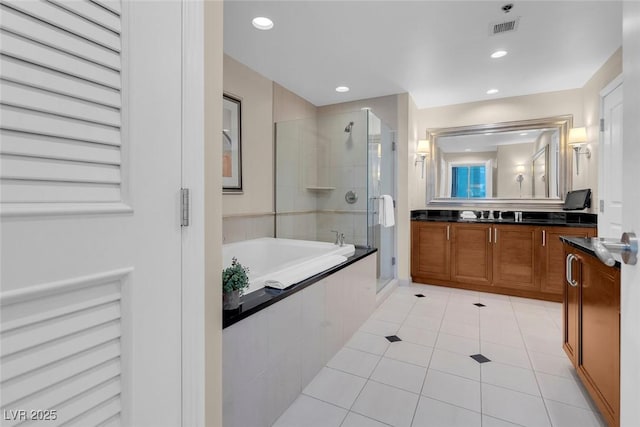 135 E Harmon Ave Unit 1621, Las Vegas, NV 89109 - bathroom featuring vanity, a shower stall, a garden tub, tile patterned floors, and recessed lighting