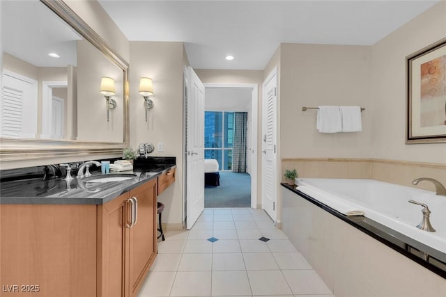 135 E Harmon Ave Unit 1621, Las Vegas, NV 89109 - ensuite bathroom featuring vanity, a garden tub, tile patterned floors, recessed lighting, and baseboards