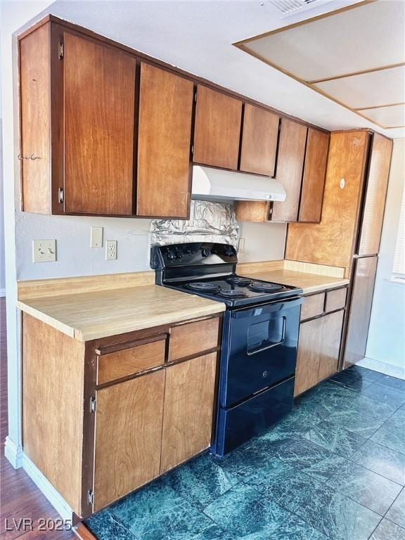 4331 Sanderling Cir Unit 46, Las Vegas, NV 89103 - kitchen with black electric range, range hood, baseboards, light countertops, and brown cabinetry