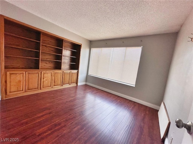 4331 Sanderling Cir Unit 46, Las Vegas, NV 89103 - empty room with a textured ceiling, dark wood-style floors, and baseboards