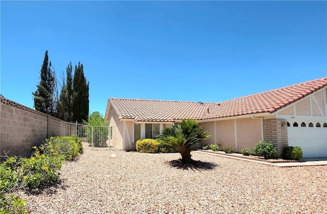 1536 Brocado Ln, Las Vegas, NV 89117 - view of front of house featuring an attached garage, a tiled roof, and stucco siding