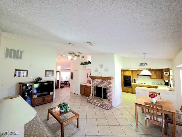 1536 Brocado Ln, Las Vegas, NV 89117 - living area featuring lofted ceiling, a textured ceiling, light tile patterned floors, a fireplace, and ceiling fan