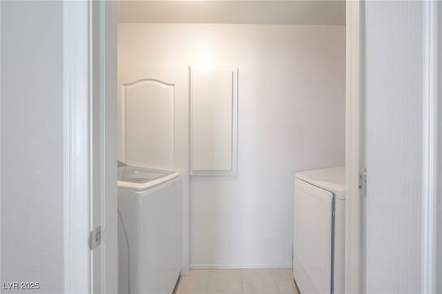 9032 Retro Ct, Las Vegas, NV 89149 - washroom with washer and dryer, light tile patterned floors, and baseboards