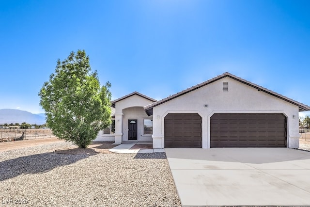 861 S Ford Loop, Pahrump, NV 89048 - single story home with an attached garage, stucco siding, driveway, and a mountain view