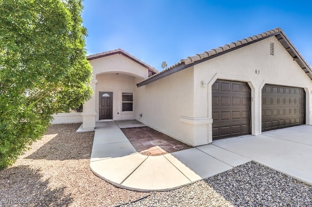 861 S Ford Loop, Pahrump, NV 89048 - view of front of home featuring stucco siding, a garage, a tiled roof, and driveway