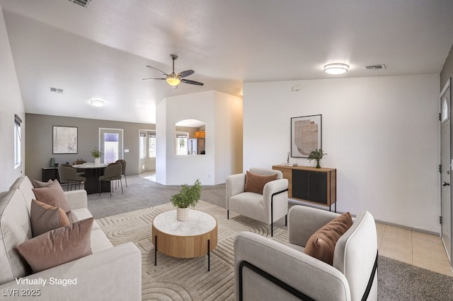 861 S Ford Loop, Pahrump, NV 89048 - living area with light carpet, a ceiling fan, vaulted ceiling, light tile patterned floors, and arched walkways