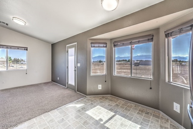 861 S Ford Loop, Pahrump, NV 89048 - unfurnished room with healthy amount of natural light, lofted ceiling, light carpet, and baseboards