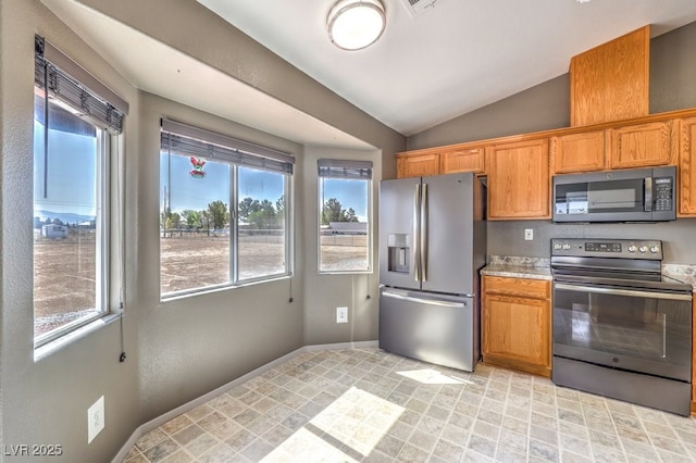 861 S Ford Loop, Pahrump, NV 89048 - kitchen with appliances with stainless steel finishes, lofted ceiling, light countertops, baseboards, and brown cabinetry