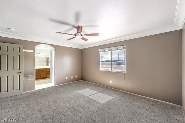 861 S Ford Loop, Pahrump, NV 89048 - unfurnished bedroom featuring crown molding, carpet floors, arched walkways, ensuite bath, and a sink