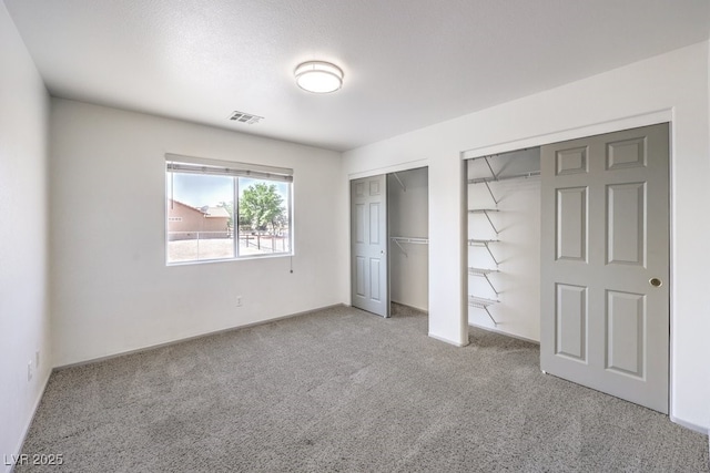 861 S Ford Loop, Pahrump, NV 89048 - unfurnished bedroom featuring carpet floors and multiple closets