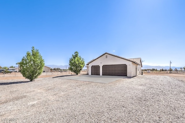 861 S Ford Loop, Pahrump, NV 89048 - garage with gravel driveway and a mountain view