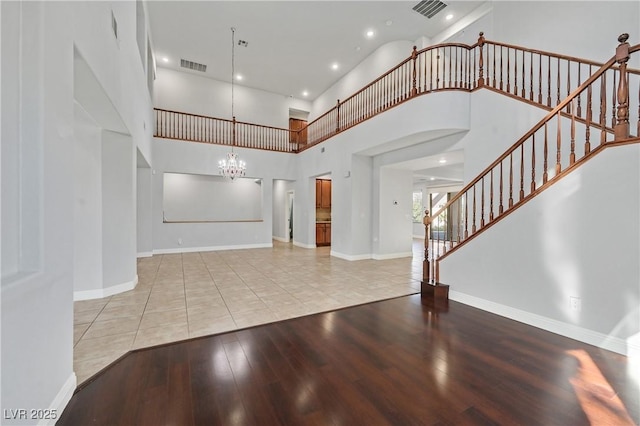 9008 Sawhill Pond St, Las Vegas, NV 89131 - entryway featuring a chandelier, hardwood / wood-style floors, stairway, a high ceiling, and baseboards