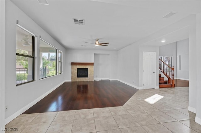 9008 Sawhill Pond St, Las Vegas, NV 89131 - unfurnished living room with ceiling fan, a tile fireplace, tile patterned floors, and stairway