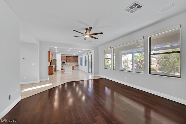 9008 Sawhill Pond St, Las Vegas, NV 89131 - unfurnished living room with a ceiling fan, baseboards, and light wood-type flooring