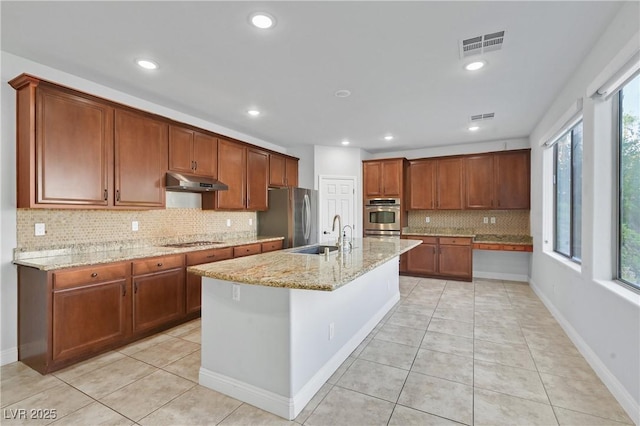 9008 Sawhill Pond St, Las Vegas, NV 89131 - kitchen featuring a sink, appliances with stainless steel finishes, under cabinet range hood, tasteful backsplash, and light stone counters