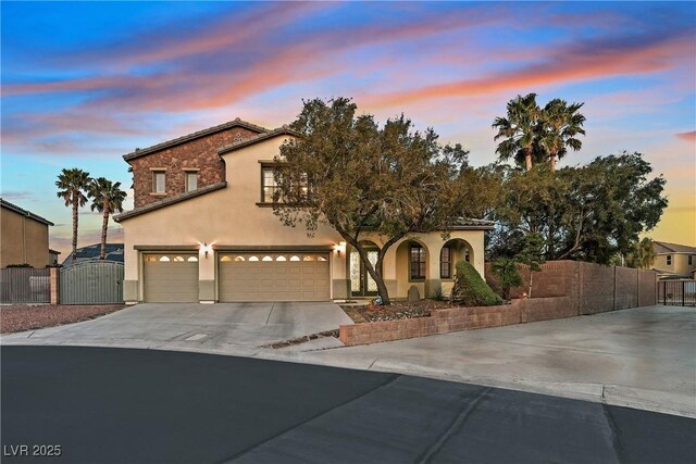 9008 Sawhill Pond St, Las Vegas, NV 89131 - mediterranean / spanish-style house with concrete driveway, a gate, a garage, and stucco siding