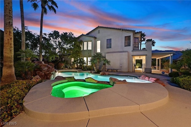 9008 Sawhill Pond St, Las Vegas, NV 89131 - pool at dusk with a patio area and a pool with connected hot tub