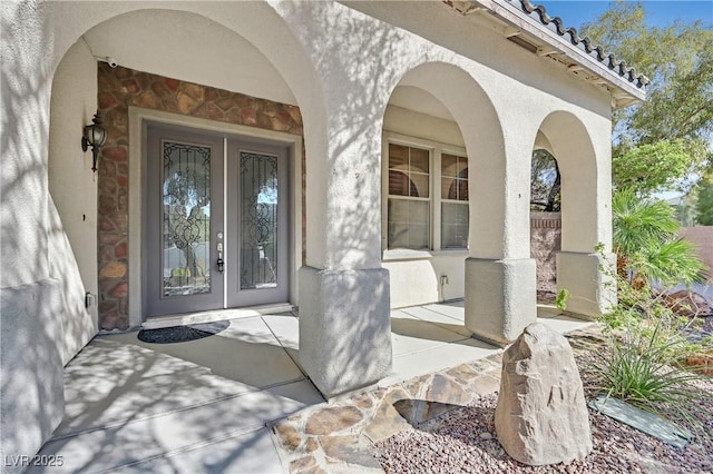 9008 Sawhill Pond St, Las Vegas, NV 89131 - property entrance with french doors, stone siding, and stucco siding