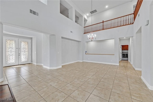 9008 Sawhill Pond St, Las Vegas, NV 89131 - unfurnished living room featuring tile patterned floors, a towering ceiling, french doors, baseboards, and a chandelier
