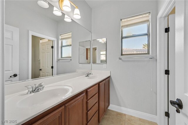 9008 Sawhill Pond St, Las Vegas, NV 89131 - bathroom with double vanity, baseboards, and tile patterned floors